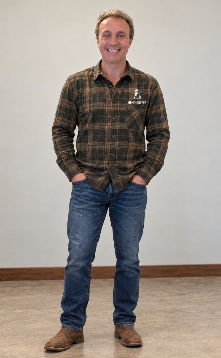 Justin, head consultant at Hempioneers, standing in a plaid flannel shirt, jeans and leather boots